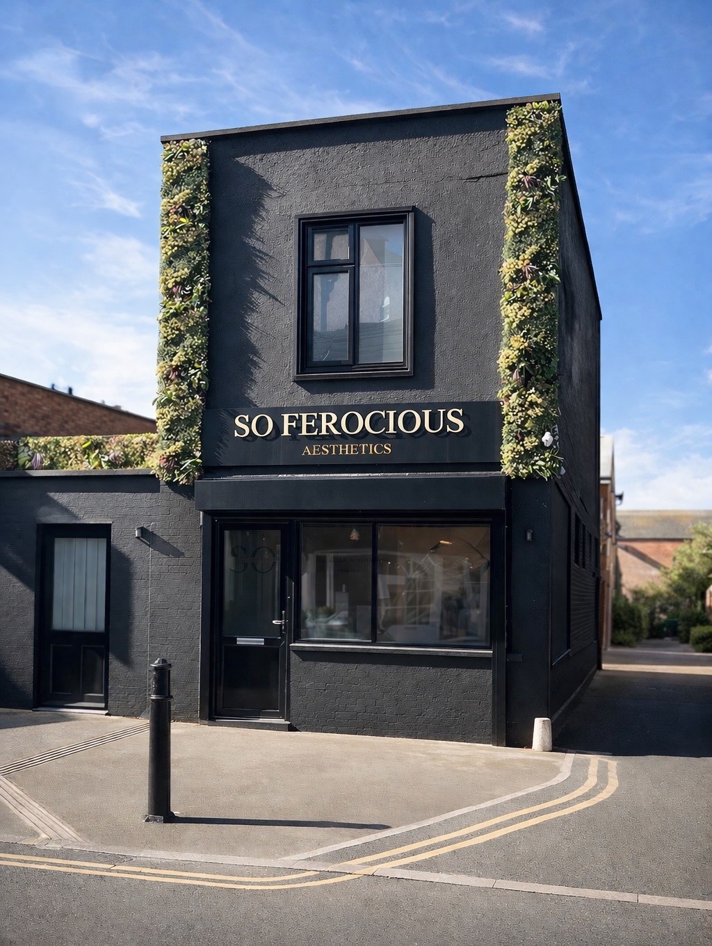 The black exterior and gold signage of So Ferocious Aesthetics